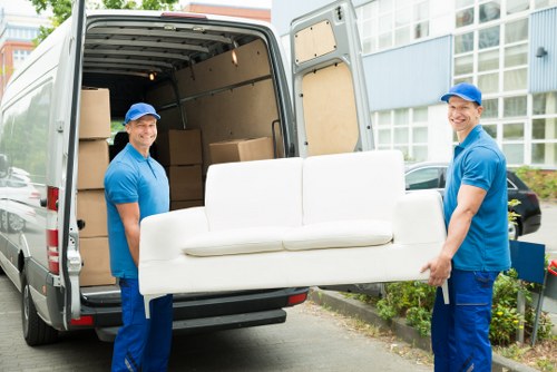 Man and van in Highbury loading boxes outside a period terrace