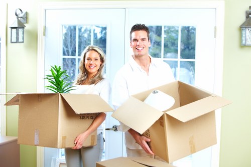 Professional movers handling furniture and boxes during a Highbury relocation