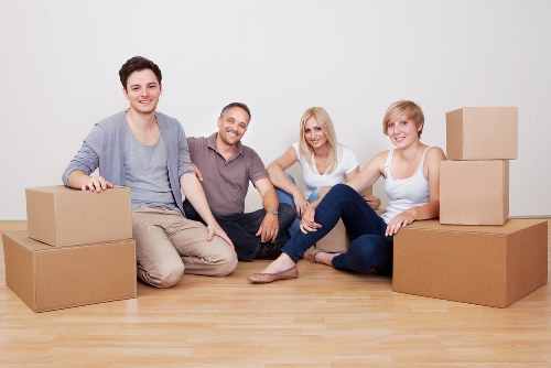 Boxes and furniture being carried through a Highbury apartment building